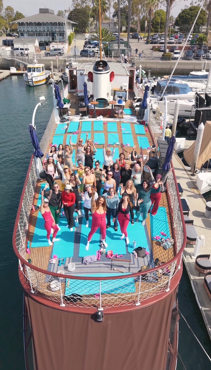 Yacht Pilates class waving from the deck in Marina del Rey