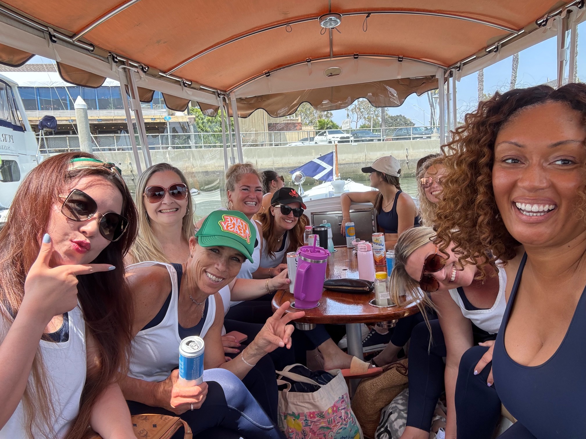 Guests smiling around a yacht table after class